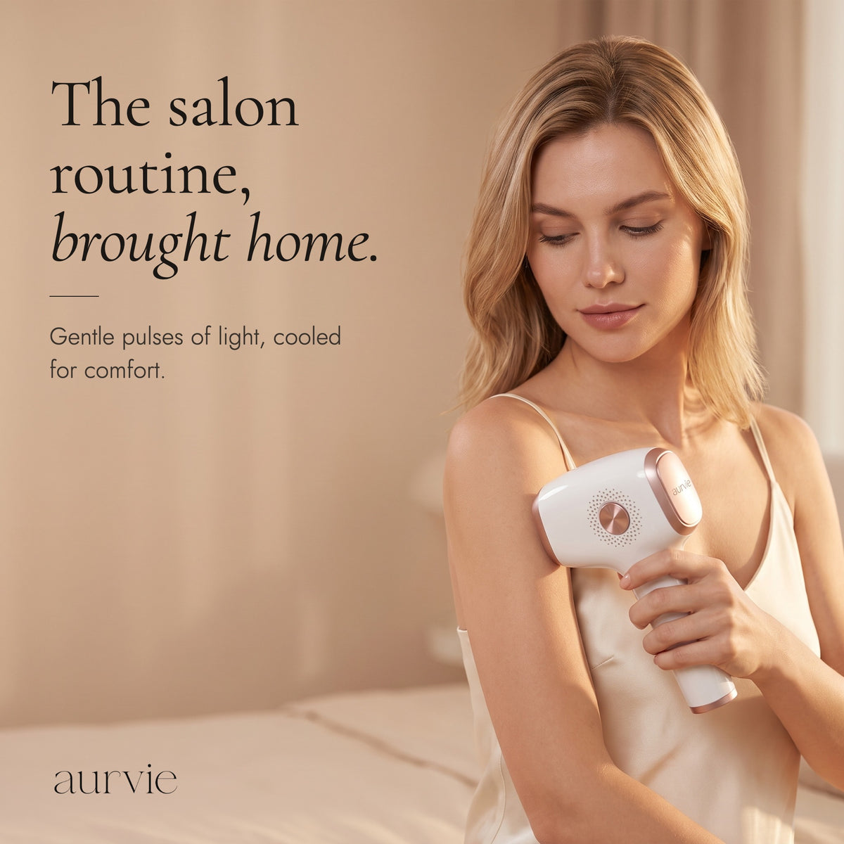 Woman holding the Aurvie IPL device against her upper arm, headline The salon routine, brought home. (ALT)